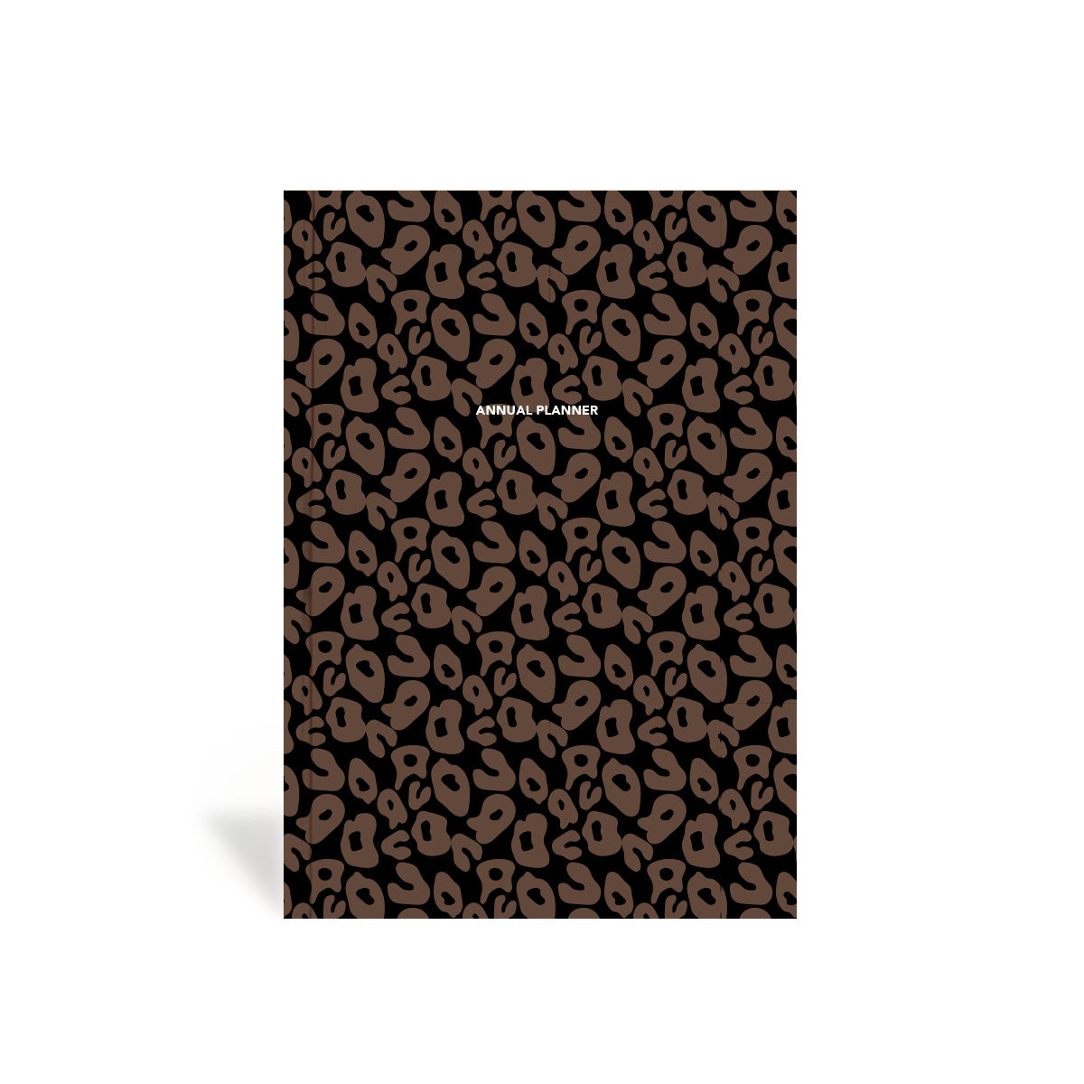 A closed undated weekly and monthly life planner with a hardbound cover featuring a leopard print pattern.