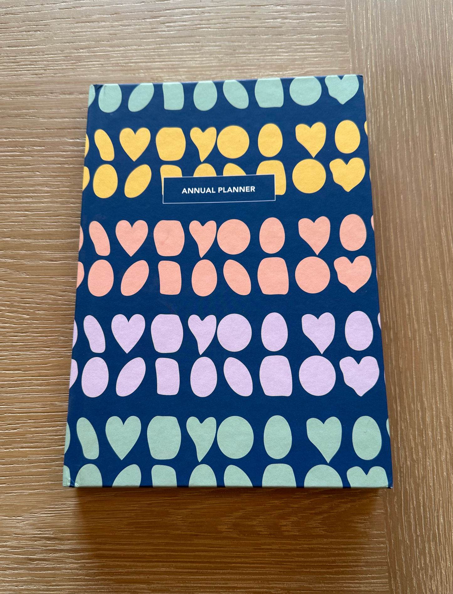 Multi Color Annual Planner on a coffee table.